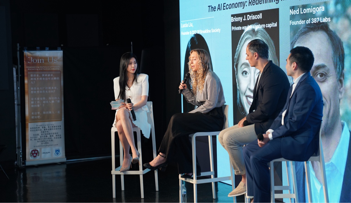 Lucia Liu moderating an on-stage panel at a Breakline Society program